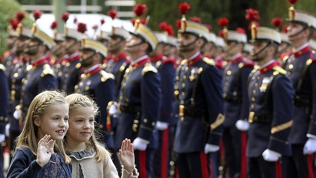 La Princesa de Asturias saluda, junto a su hermana Sofía en el desfile de la Fiesta Nacional,